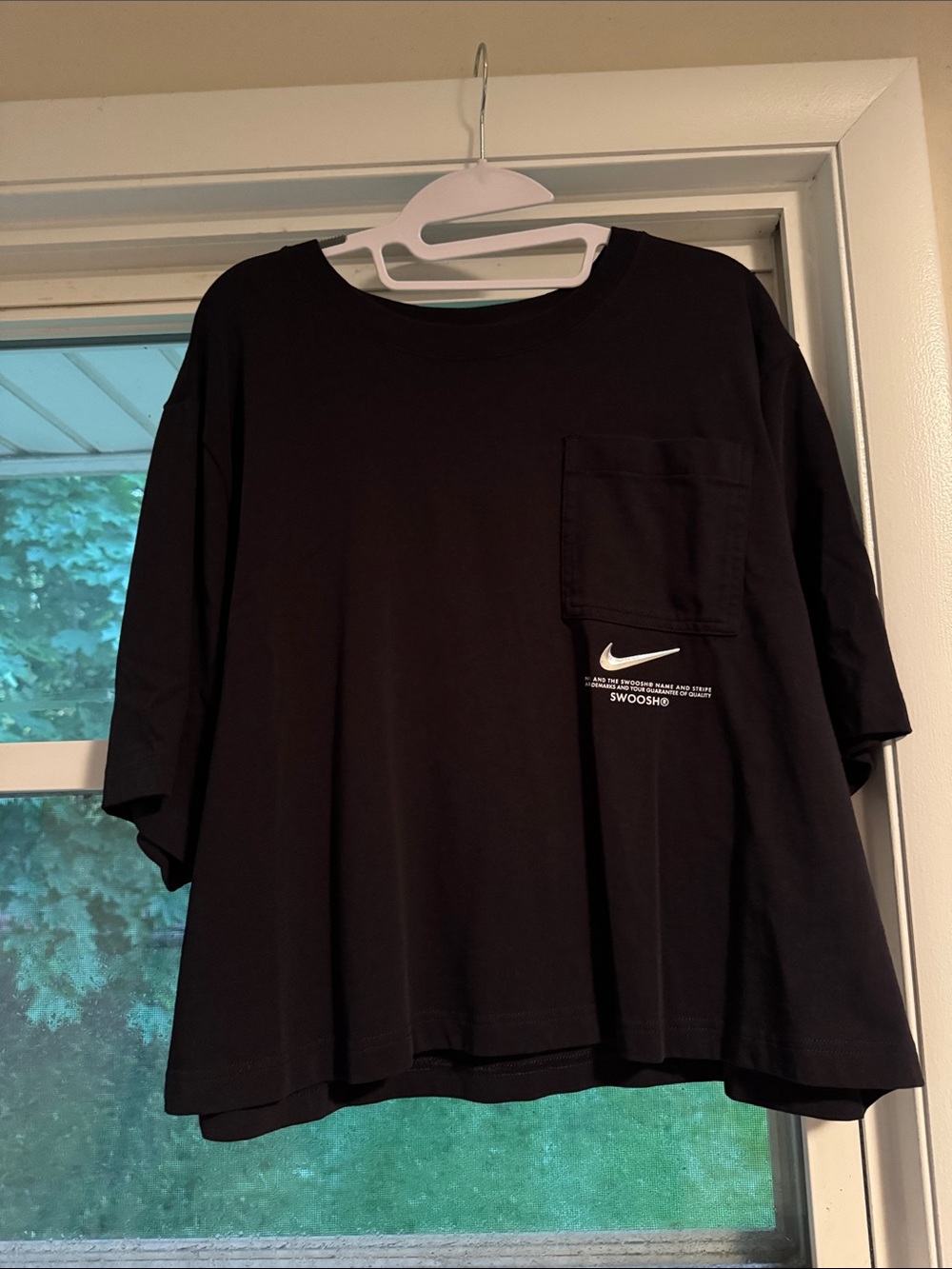 Women’s Nike Black cropped pocket Tee with silver Swoosh